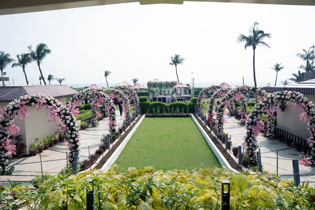 Beachfront event lawn with floral arches